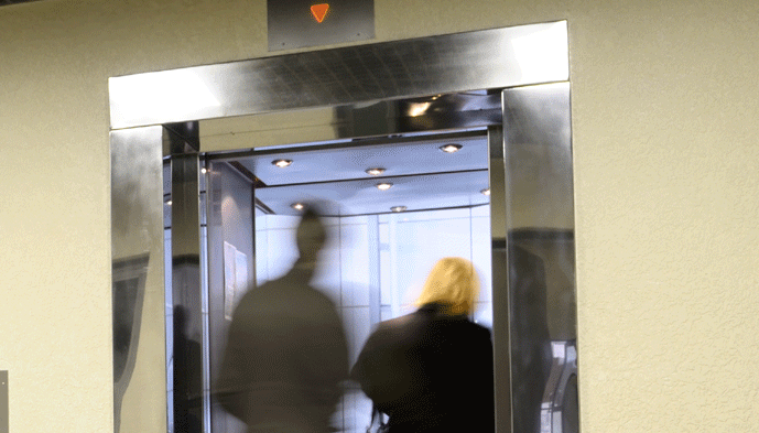 people walking into open elevator